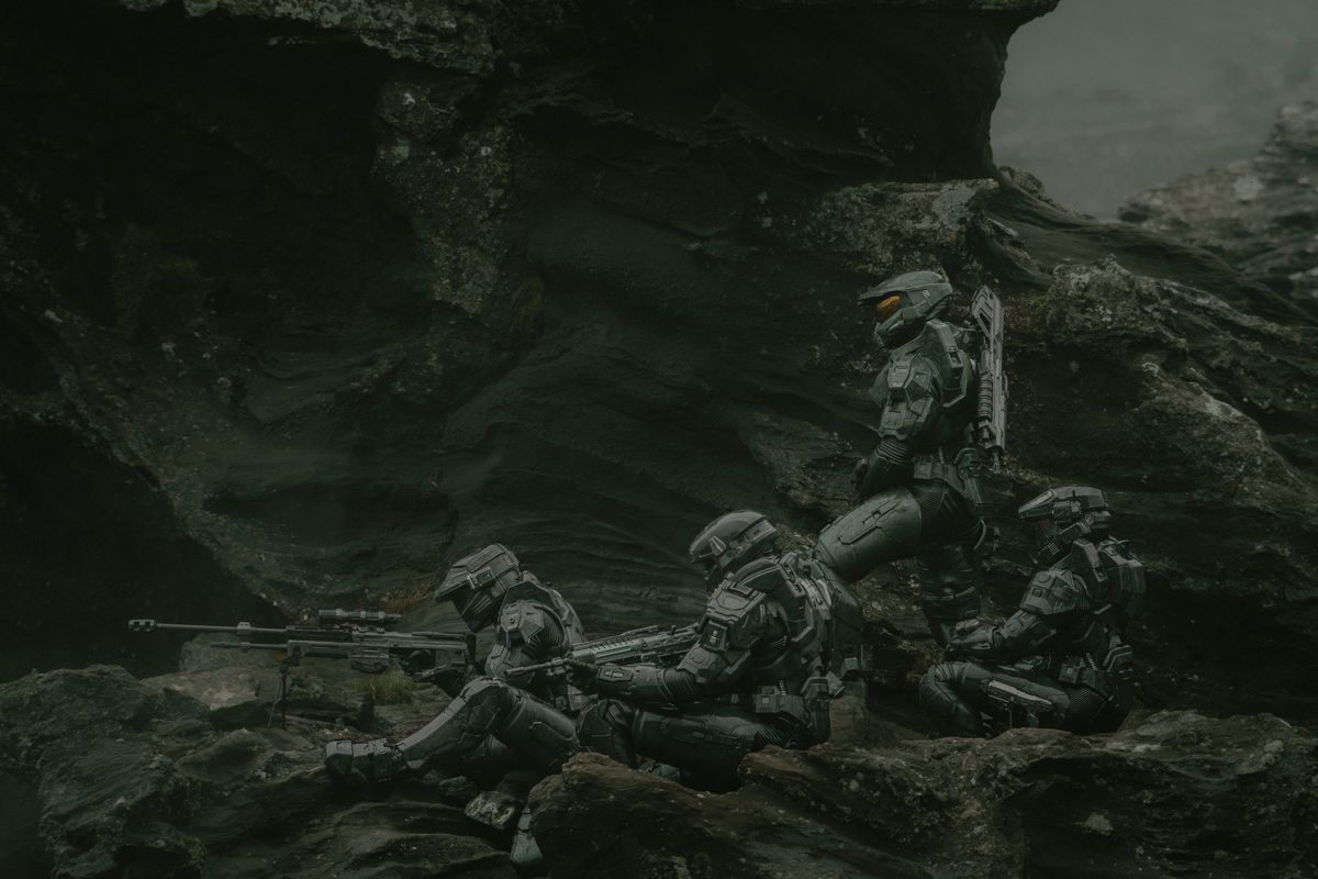 Several Spartans stand in formation on a cliff watching something through rifle scopes in Paramount Plus’ Halo season 2