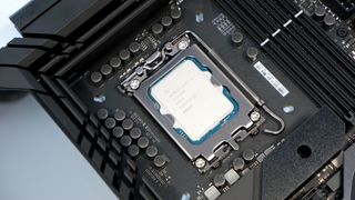 Intel Core i9 14900K CPU on a box and inside a motherboard socket.